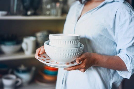 Person Carrying Clean Dishes | Dishwashing Temperature Guidelines